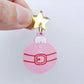 One pastel pink Santa bauble dangle with engraved Santa belt and button details paint filled in white and red, assembled with a 16mm gold mirror star topper