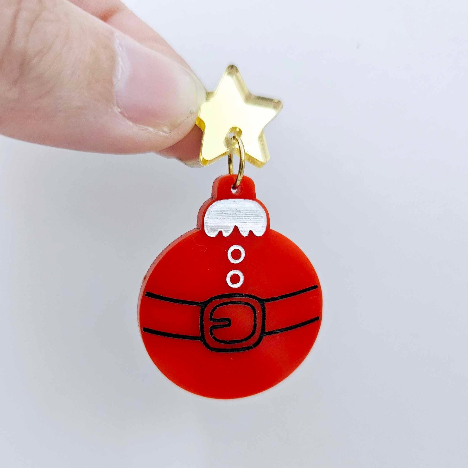 One solid red Santa bauble dangle with engraved Santa belt and button details paint filled in black and white, assembled with a 16mm gold mirror star topper