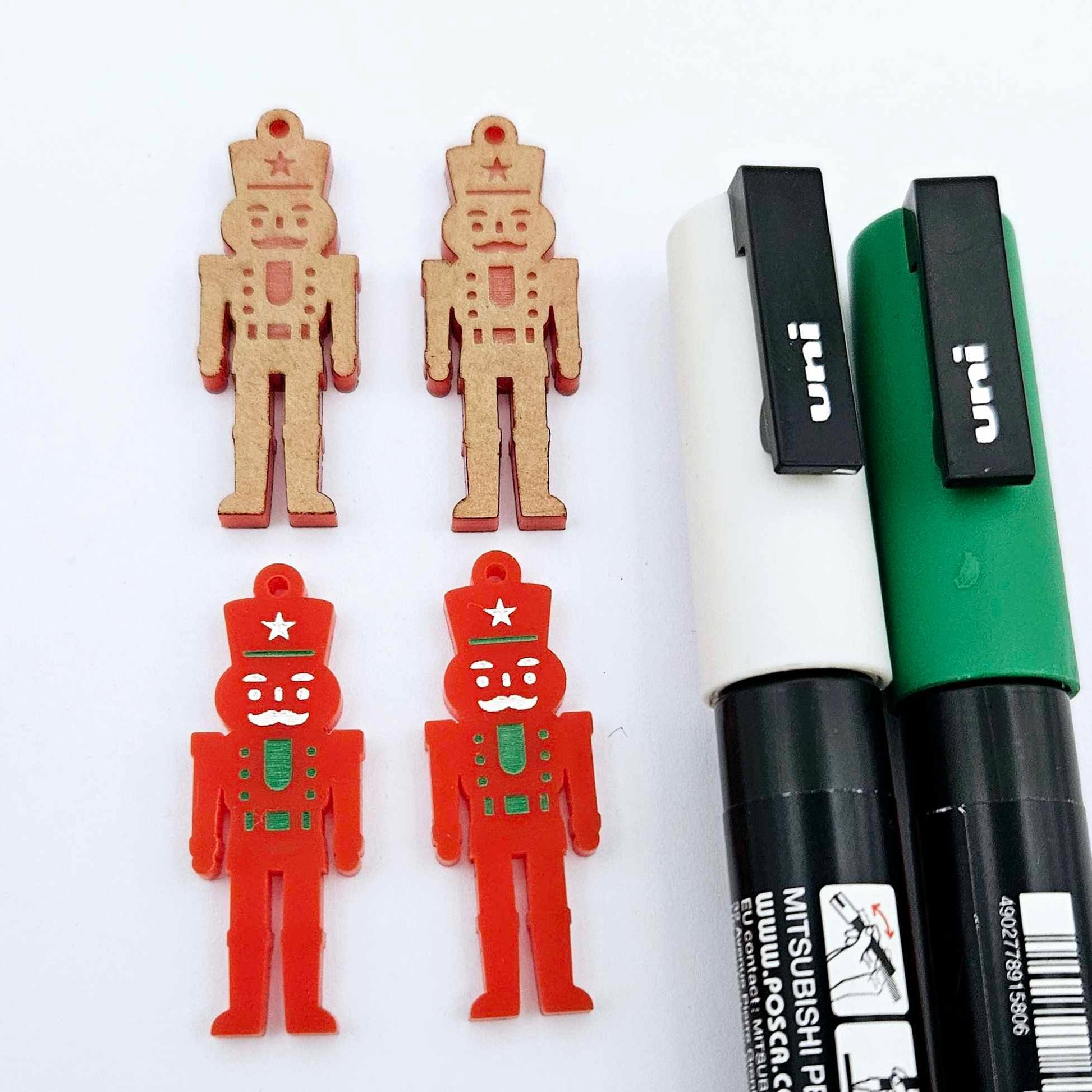 40mm nutcracker Christmas dangle blanks with engraved paint-fill details shown in  red acrylic with green and white posca paint pens
