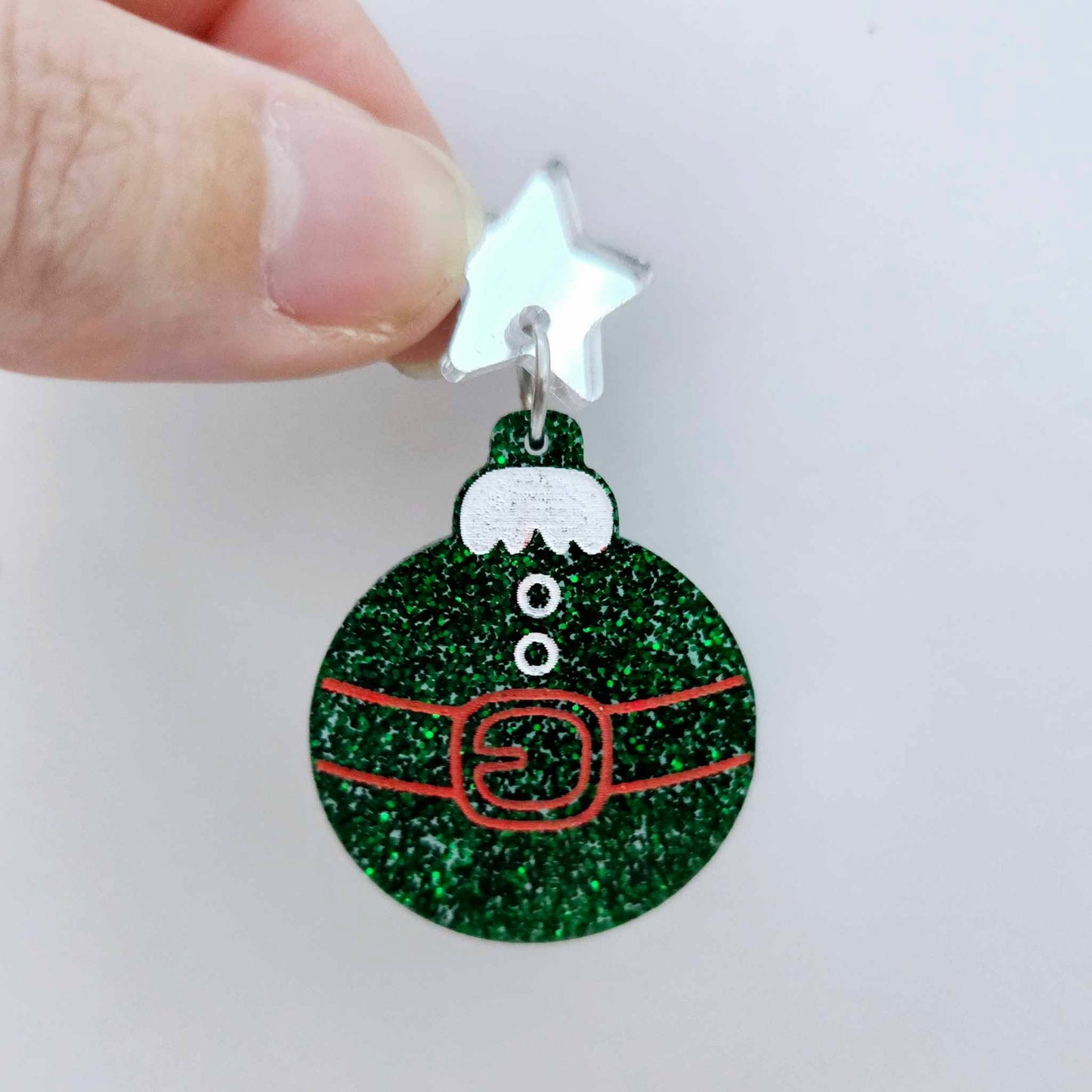 One green glitter Santa bauble dangle with engraved Santa belt and button details paint filled red and white, assembled with a 16mm silver mirror star topper