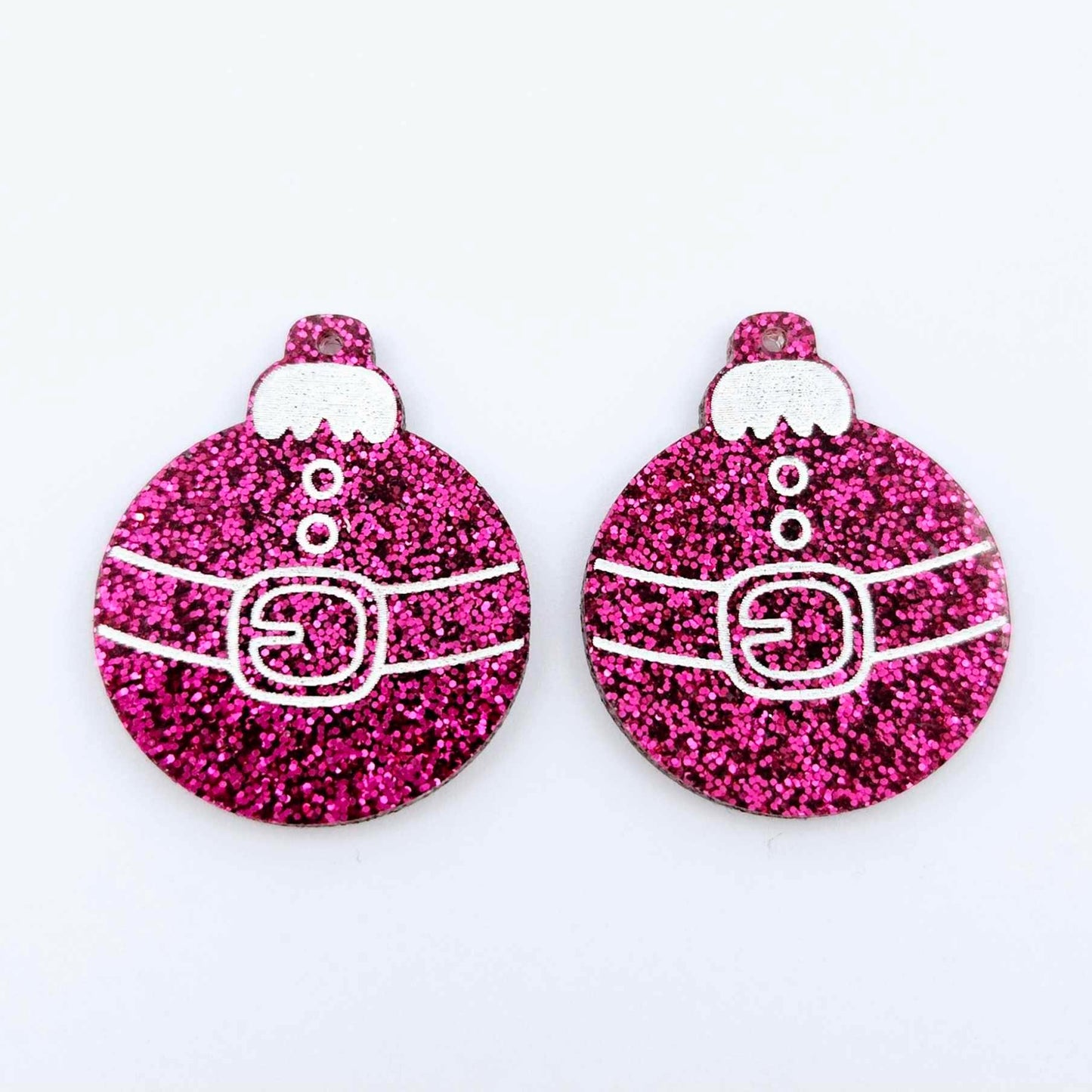 One pair of hot pink glitter Santa bauble dangle blanks with engraved Santa belt and button details paint filled white, shown laying flat