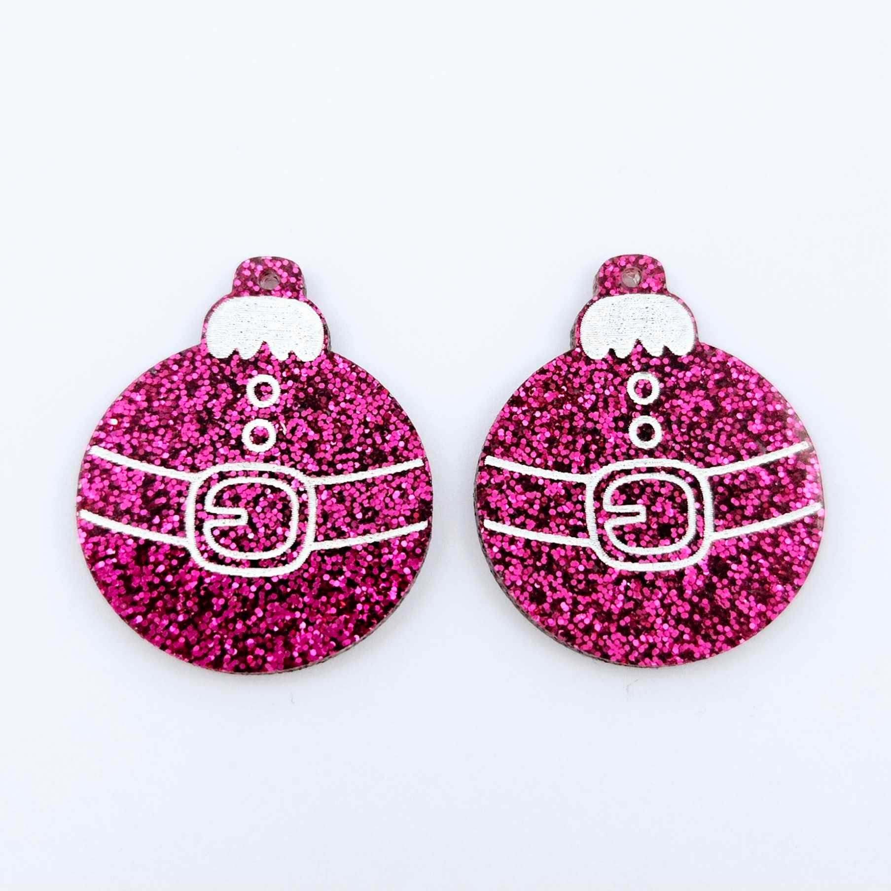 One pair of hot pink glitter Santa bauble dangle blanks with engraved Santa belt and button details paint filled white, shown laying flat