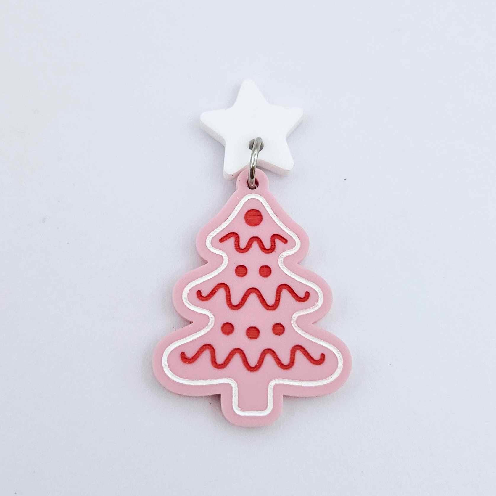 One pastel pink cookie Christmas tree dangle with engraved icing details paint filled in red and white, assembled with a 16mm white star topper