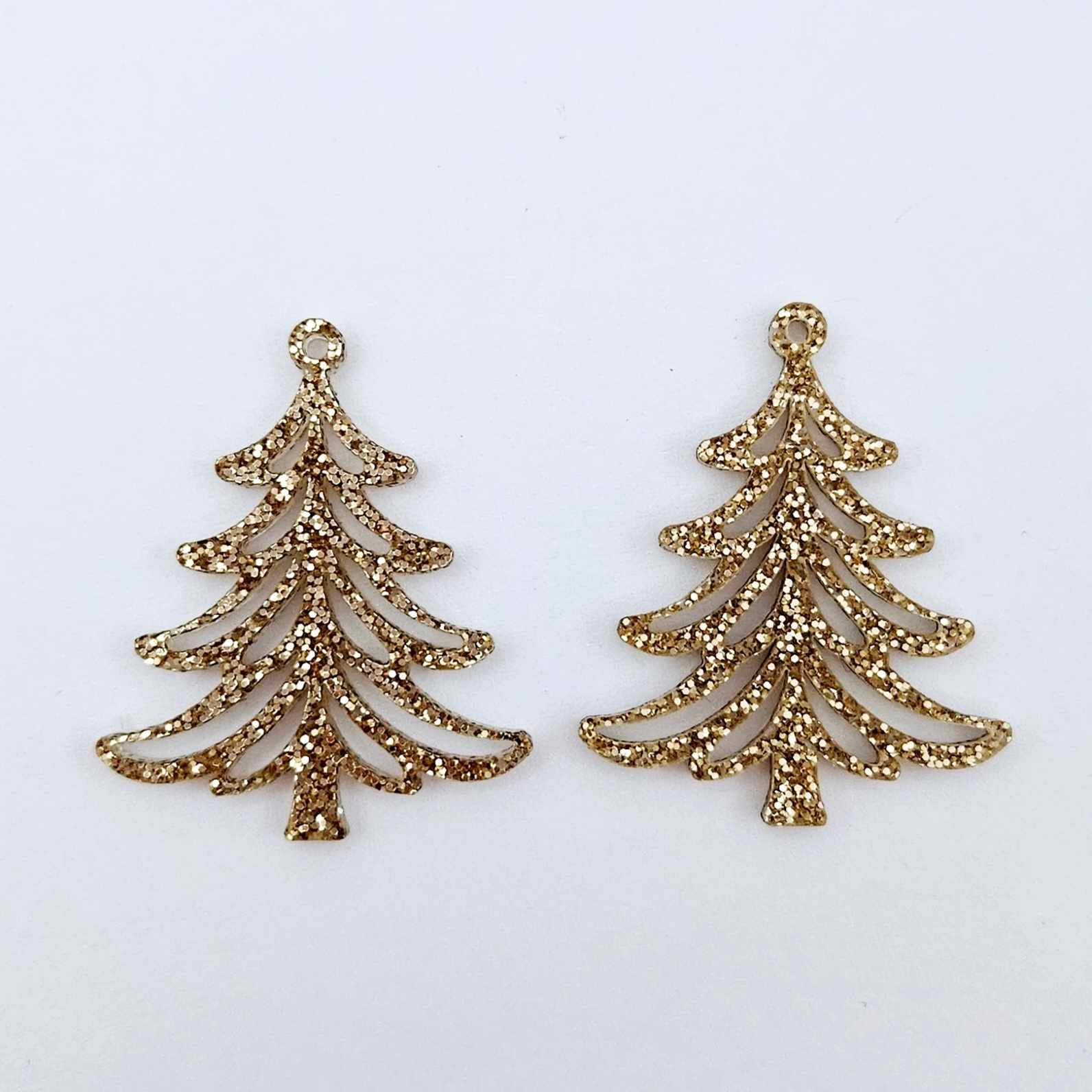 One pair of 35mm rose gold glitter Cascade Christmas Tree dangle earring blanks laying flat on a white background