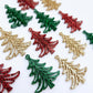 A mixture of green glitter, red glitter and rose gold glitter 35mm Cascade Christmas Tree dangle earring blanks laying flat on a white background.