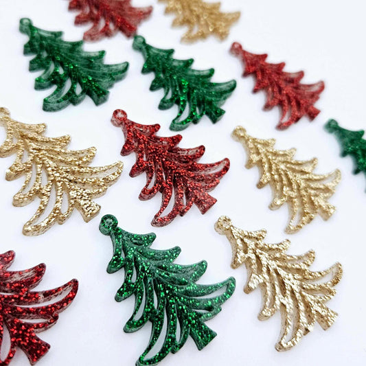 A mixture of green glitter, red glitter and rose gold glitter 35mm Cascade Christmas Tree dangle earring blanks laying flat on a white background.