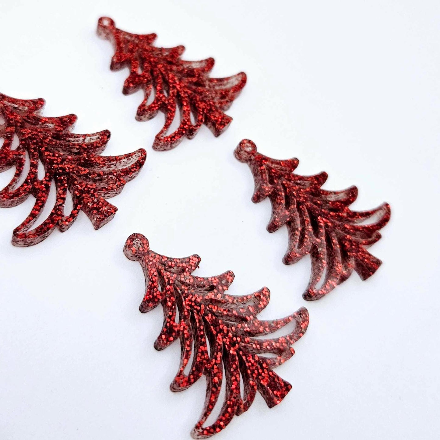 Two pairs of 35mm red glitter Cascade Christmas Tree dangle earring blanks laying flat on a white background.