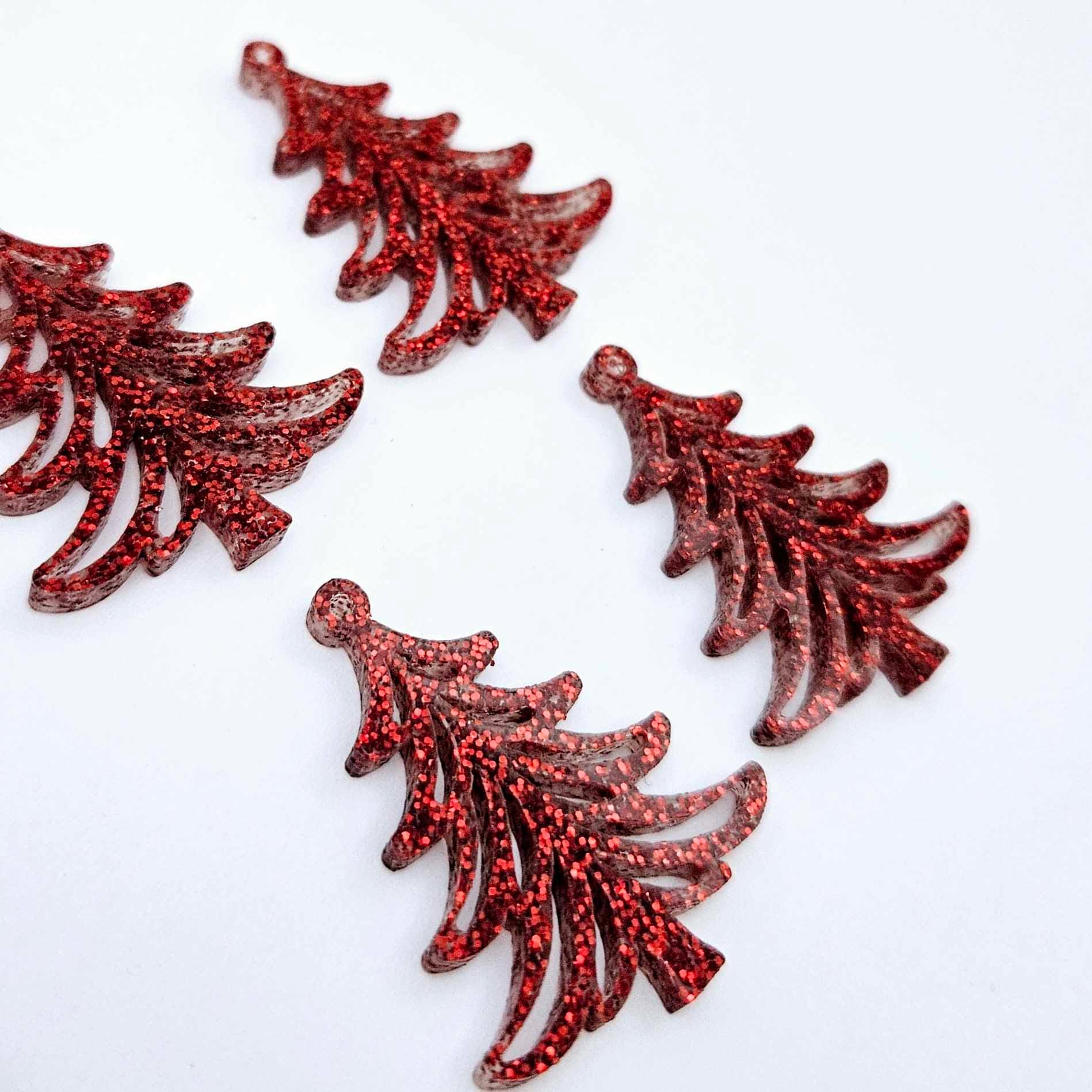 Two pairs of 35mm red glitter Cascade Christmas Tree dangle earring blanks laying flat on a white background.