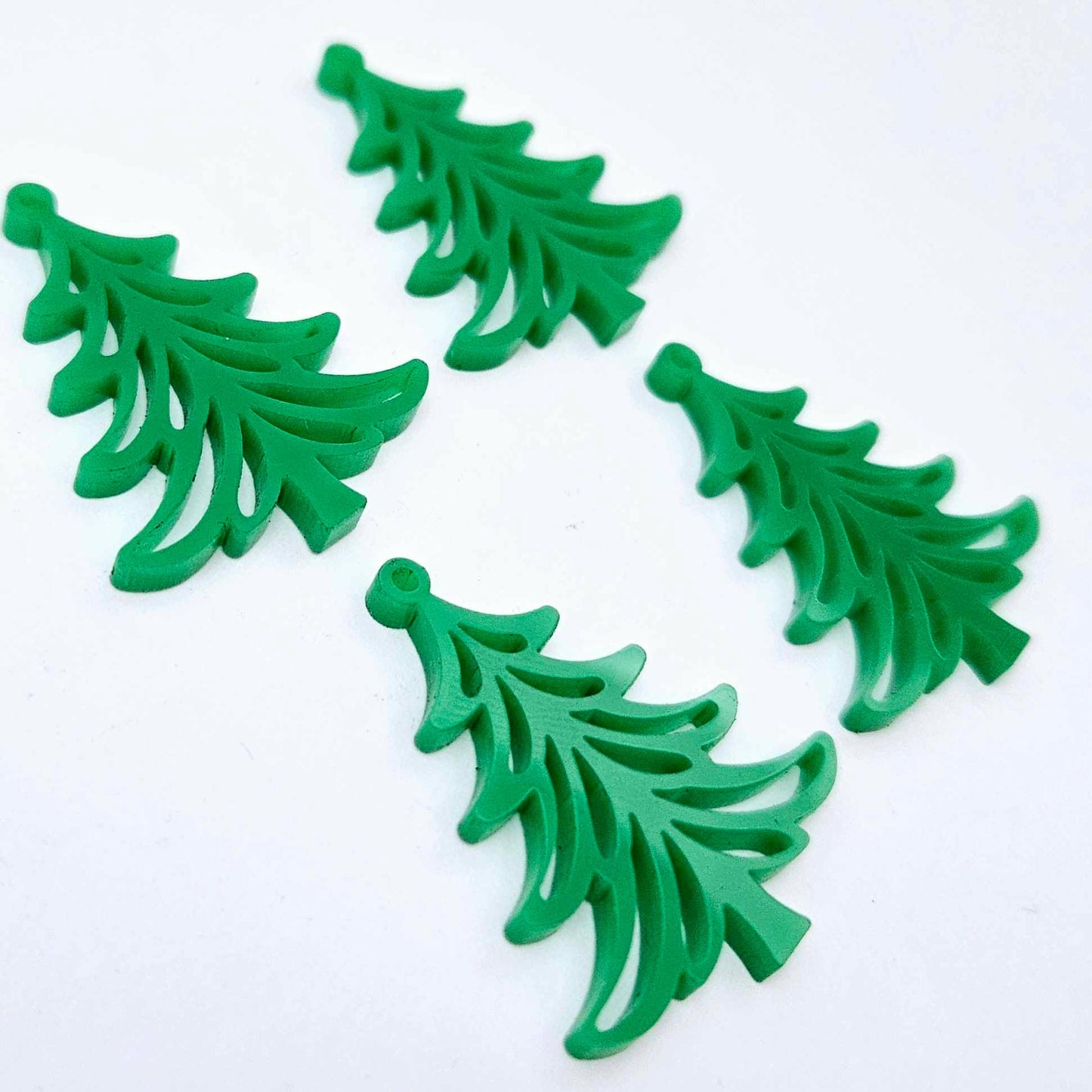 Two pairs of 35mm solid green Cascade Christmas Tree dangle earring blanks laying flat on a white background