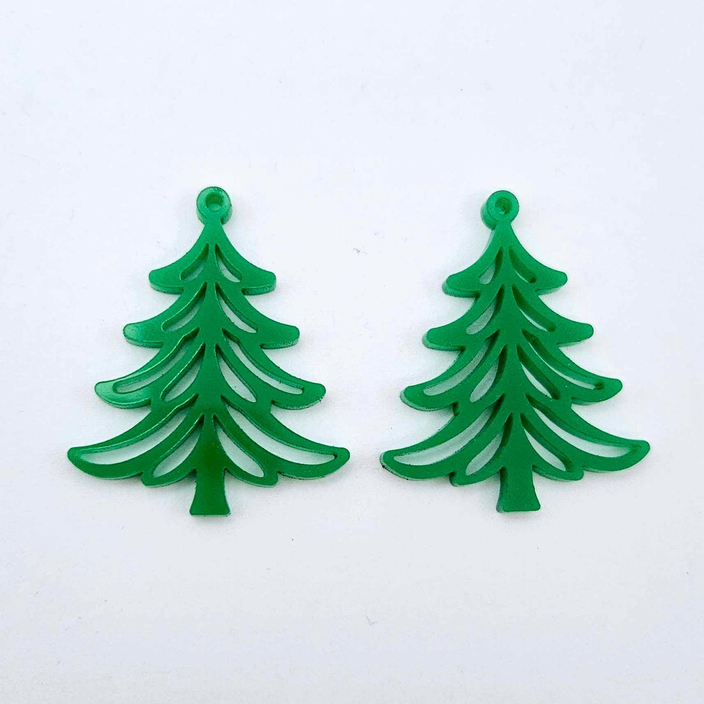 One pair of 35mm solid green Cascade Christmas Tree dangle earring blanks laying flat on a white background.