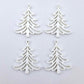 Two pairs of 35mm white acrylic Cascade Christmas Tree dangle blanks laying flat on a white background