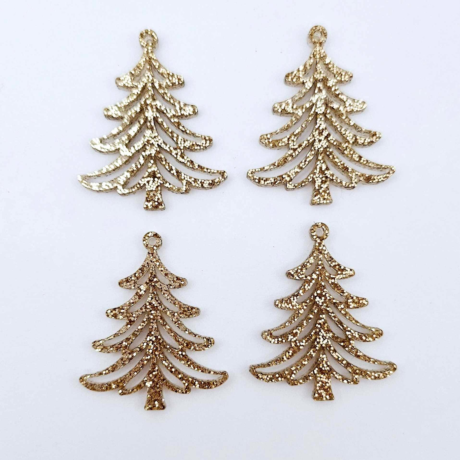 Two pairs of 35mm rose gold glitter Cascade Christmas Tree dangle earring blanks laying flat on a white background