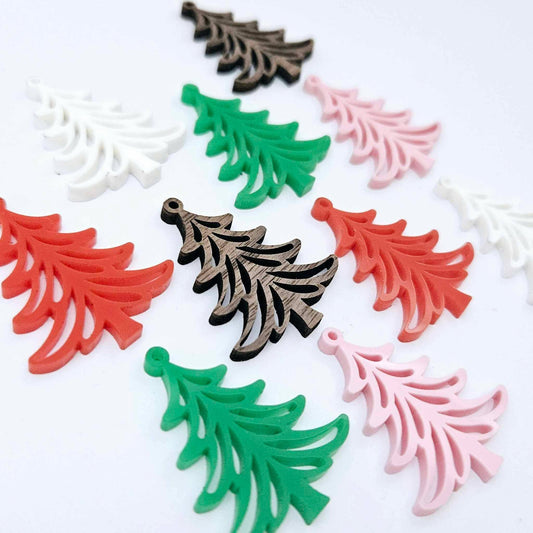 A mixture of solid green, solid red, white, pastel pink and walnut veneer 35mm Cascade Christmas Tree dangle earring blanks laying flat on a white background