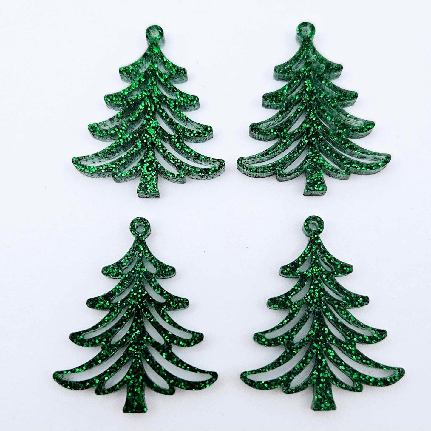 Two pairs of 35mm green glitter acrylic Cascade Christmas Tree dangle earring blanks laying flat on a white background.