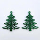 One pair of 35mm green glitter acrylic Cascade Christmas Tree dangle earring blanks laying flat on a white background.
