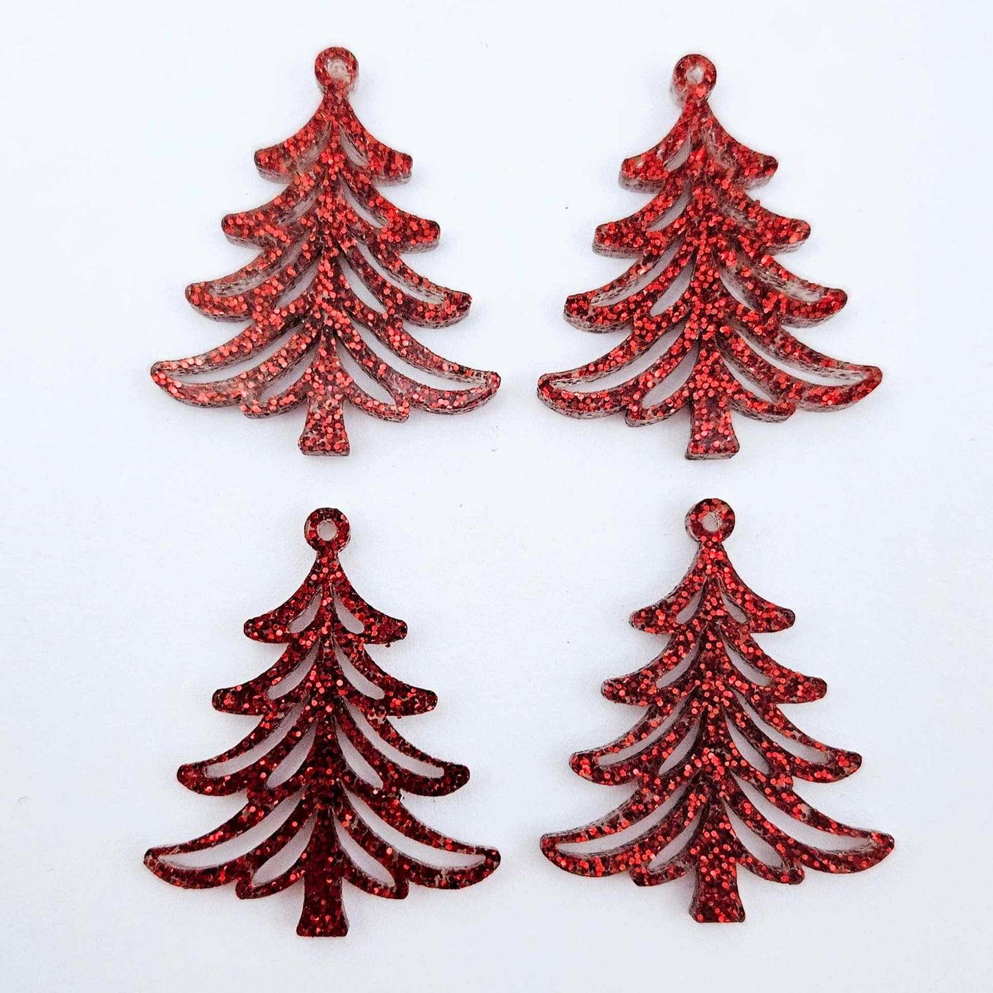 Two pairs of 35mm red glitter Cascade Christmas Tree dangle earring blanks laying flat on a white background