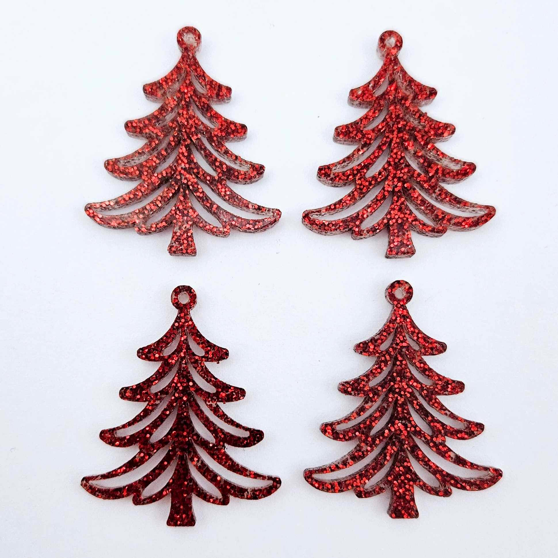 Two pairs of 35mm red glitter Cascade Christmas Tree dangle earring blanks laying flat on a white background