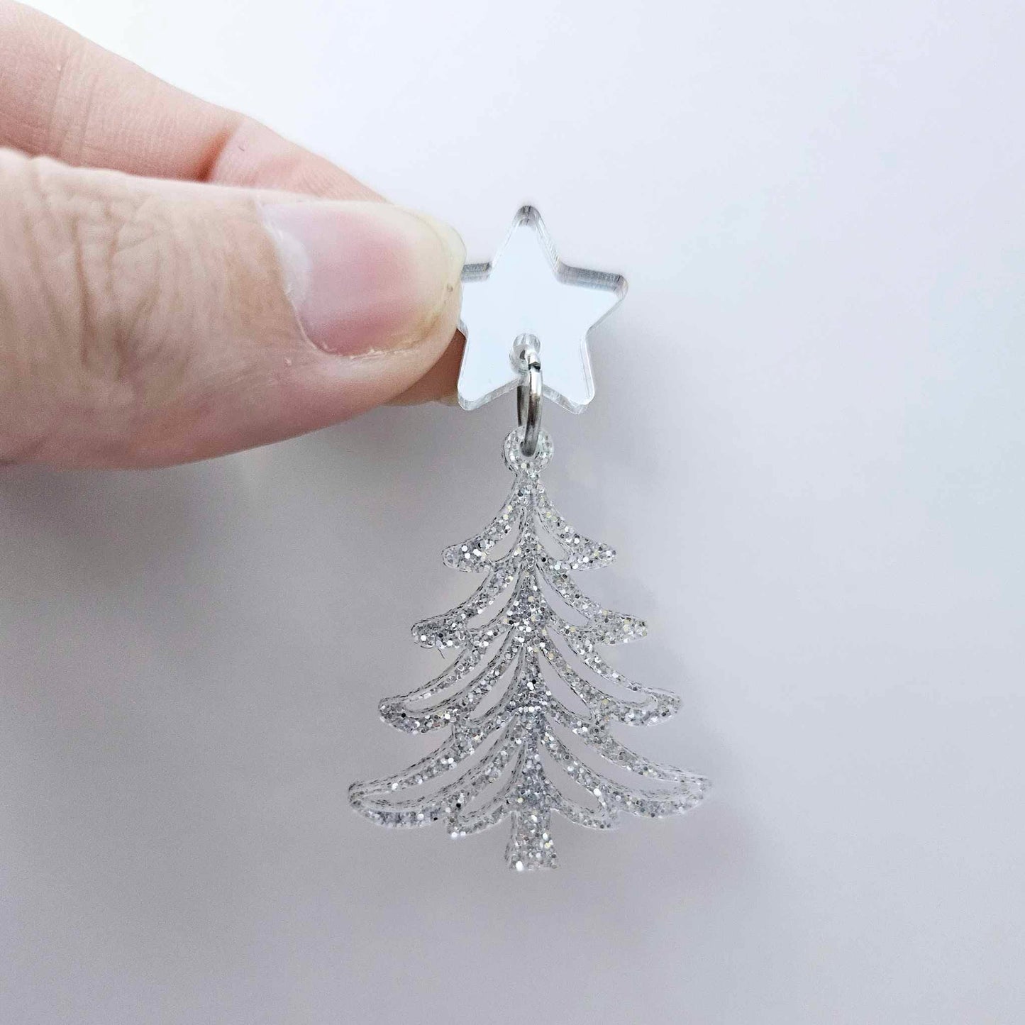 One 35mm silver glitter acrylic  Cascade Christmas Tree dangle earring blank assembled with a 16mm star topper, shown as a finished earring component
