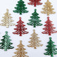 A mixture of green glitter, red glitter and rose gold glitter 35mm Cascade Christmas Tree dangle earring blanks laying flat on a white background.