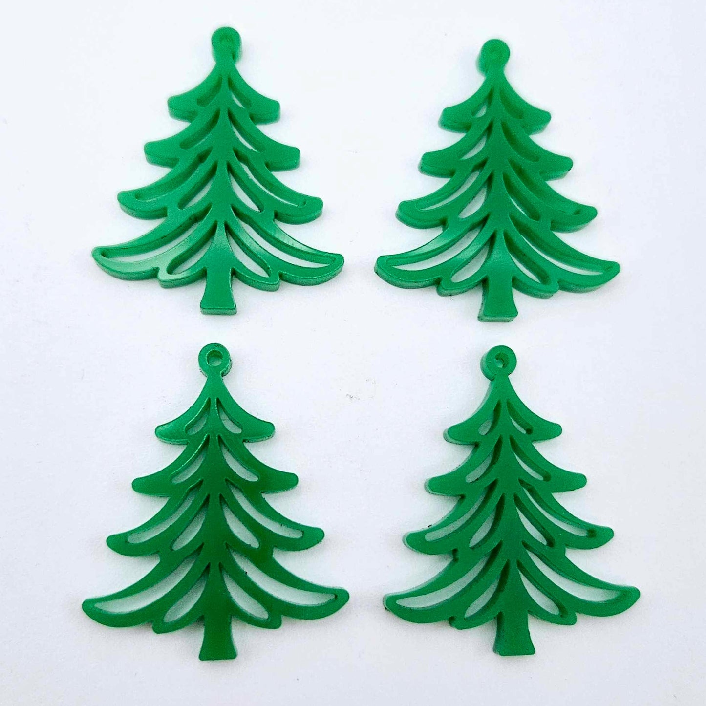 Two pairs of 35mm solid green Cascade Christmas Tree dangle earring blanks laying flat on a white background