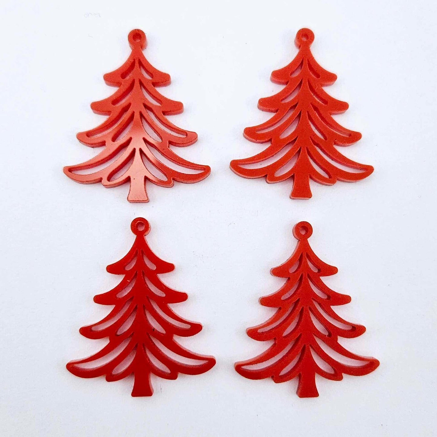 Two pairs of 35mm solid red Cascade Christmas Tree dangle blanks laying flat on a white background