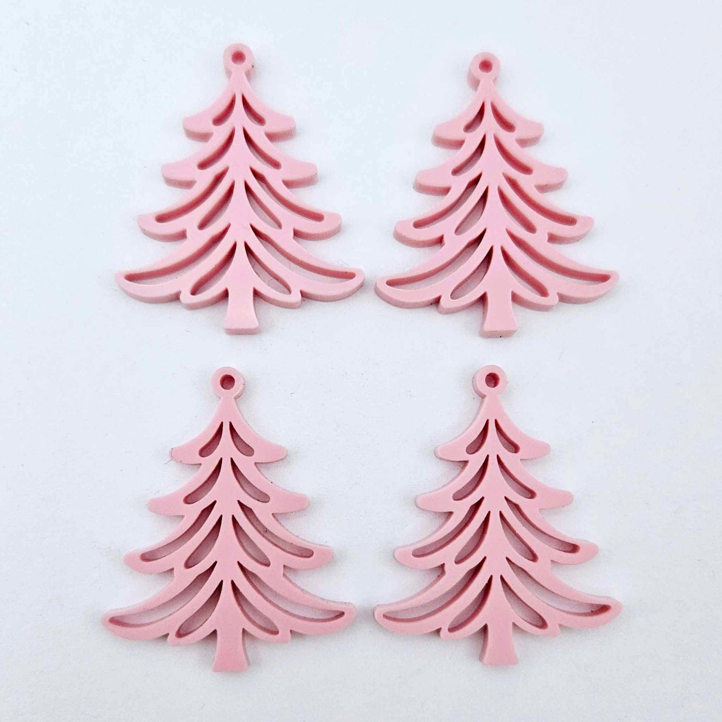 Two pairs of 35mm pastel pink acrylic Cascade Christmas Tree dangle earring blanks laying flat on a white background