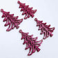 Two pairs of 35mm hot pink glitter Cascade Christmas Tree dangle blanks laying flat on a white background