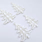 Two pairs of 35mm white acrylic Cascade Christmas Tree dangle blanks laying flat on a white background