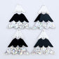 Two pairs of 40mm three piece Christmas Tree dangle earring blanks in holographic silver glitter, black and white marble acrylic laying flat on a white background