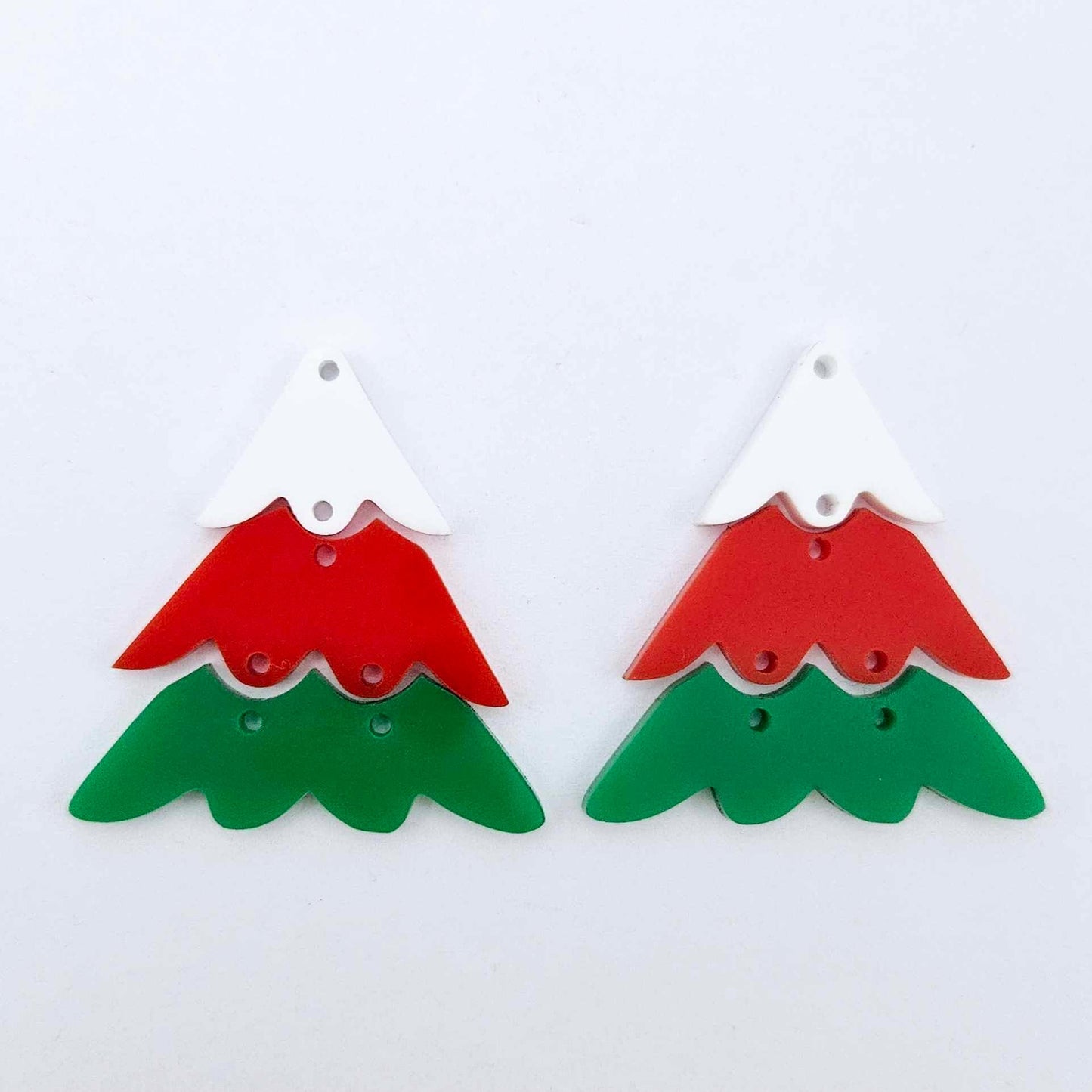 One pair of green, red and white 40mm three piece Christmas Tree dangle earring blanks laying flat