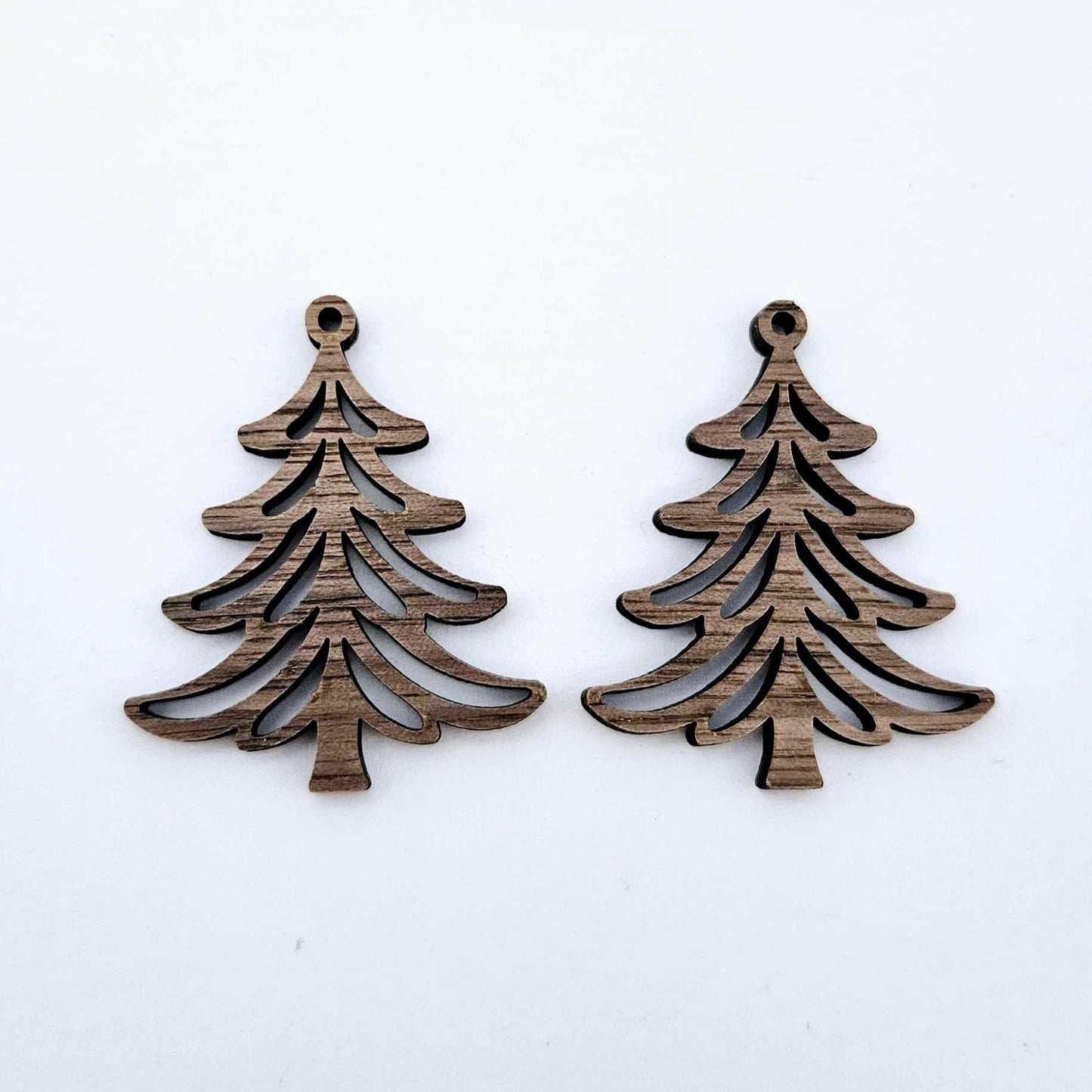 One pair of 35mm walnut veneer Cascade Christmas Tree dangle earring blanks laying flat on a white background