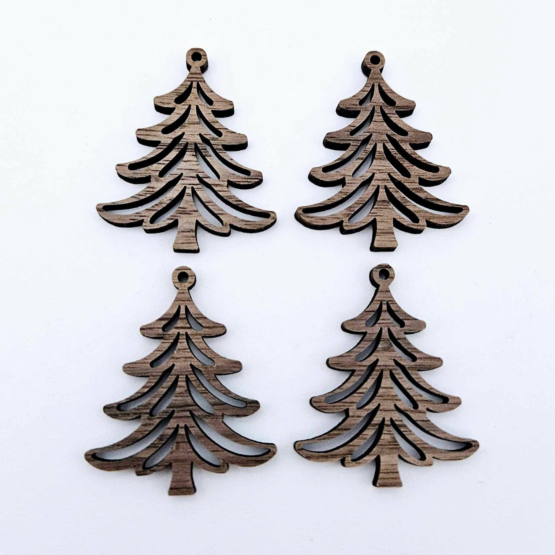 Two pairs of 35mm walnut veneer Cascade Christmas Tree dangle earring blanks laying flat on a white background