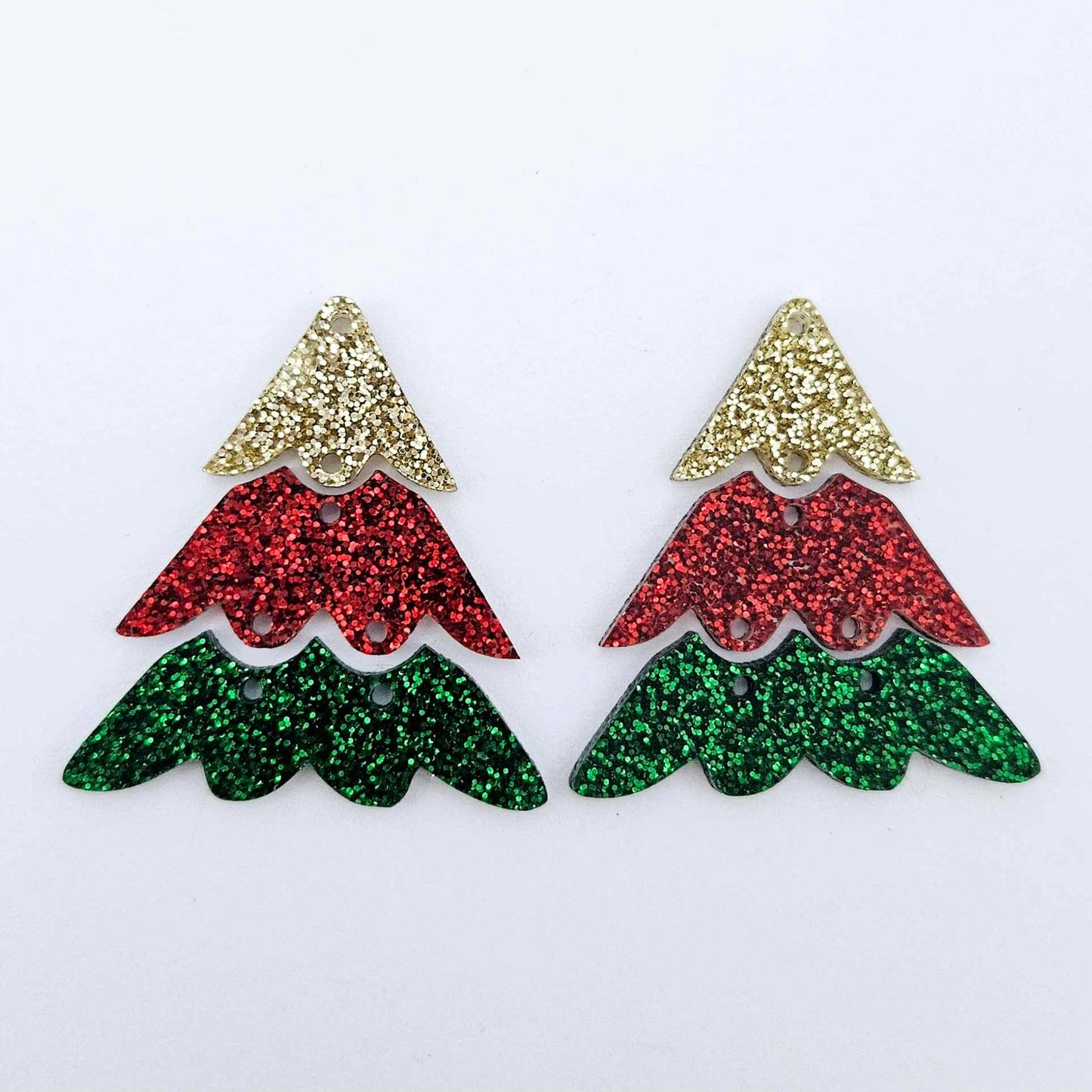 One pair of green, red and gold glitter three piece Christmas Tree dangle earring blanks laying flat