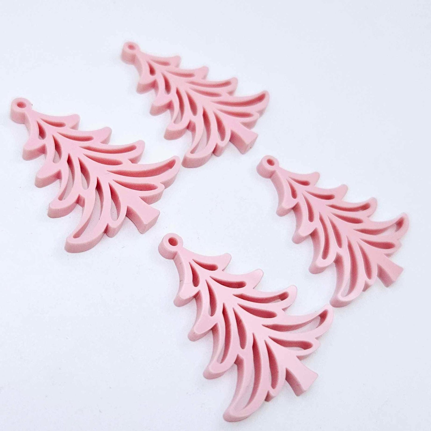 Two pairs of 35mm pastel pink acrylic Cascade Christmas Tree dangle earring blanks laying flat on a white background