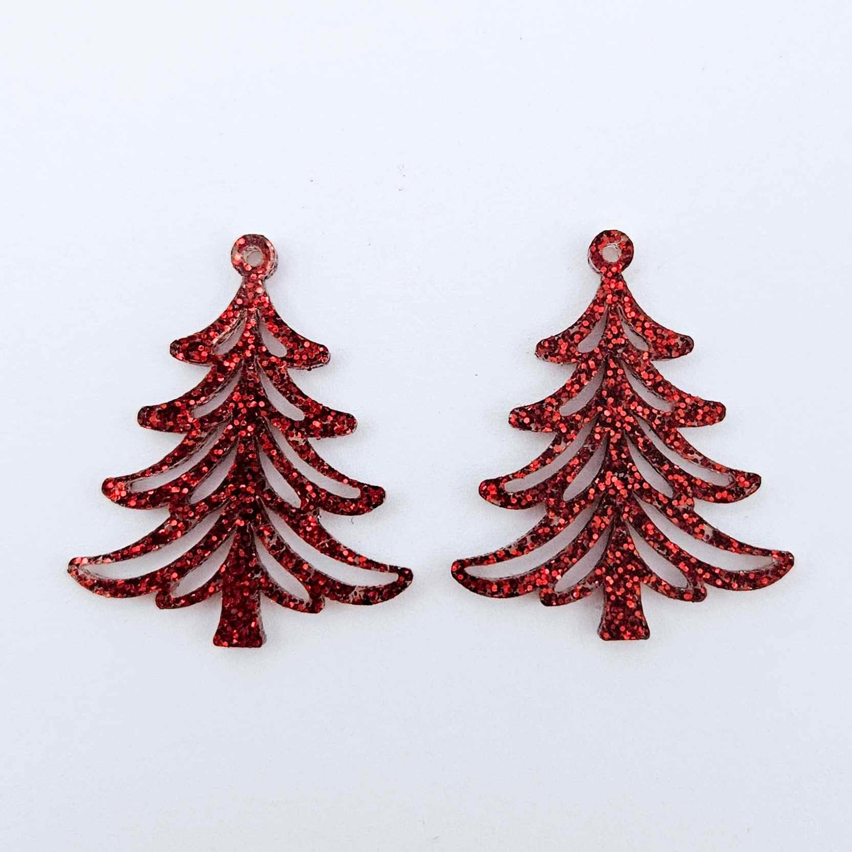 One pair of 35mm red glitter Cascade Christmas Tree dangle earring blanks laying flat on a white background