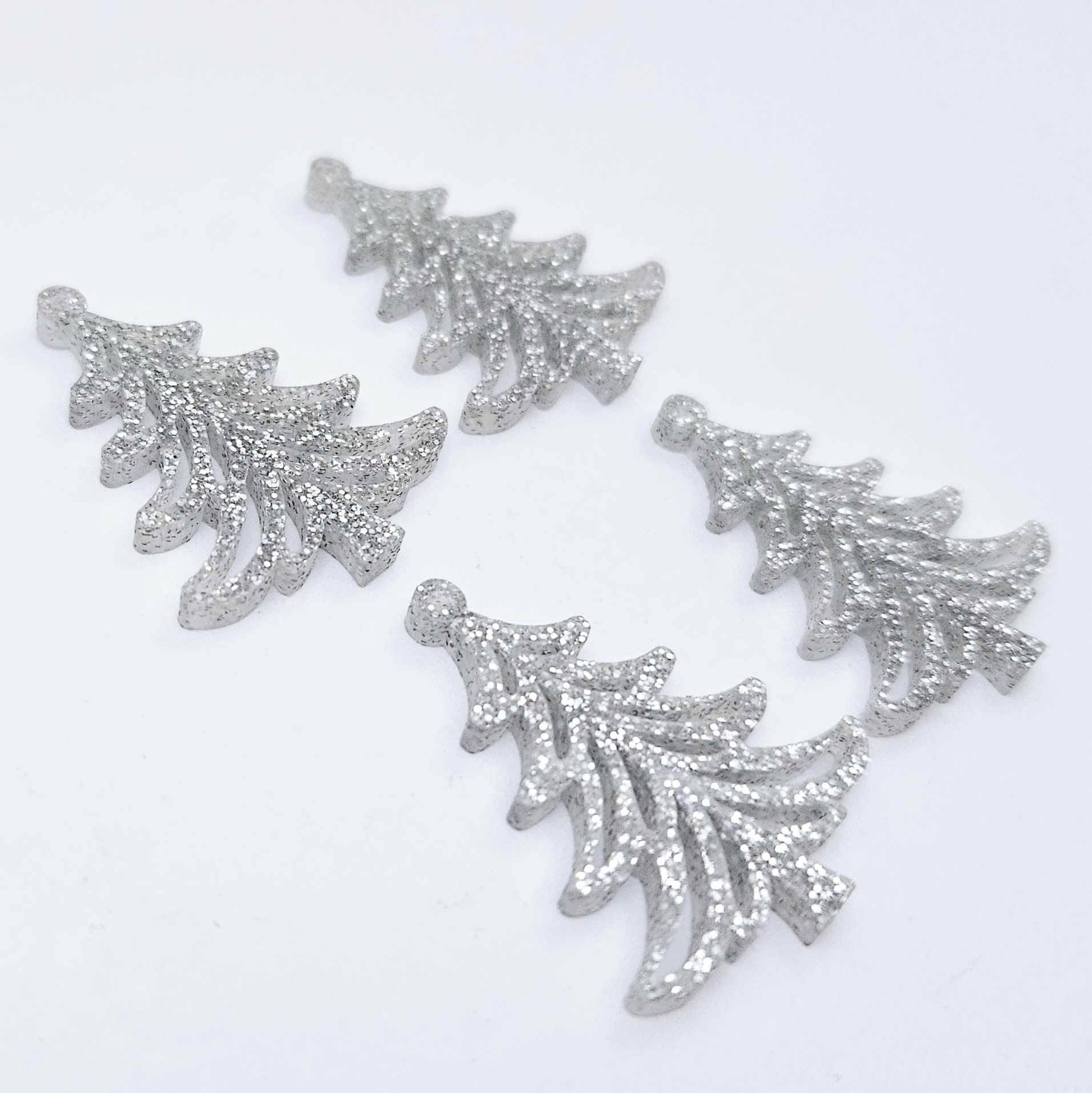 Two pairs of 35mm silver glitter acrylic Cascade Christmas Tree dangle earring blanks laying flat on a white background