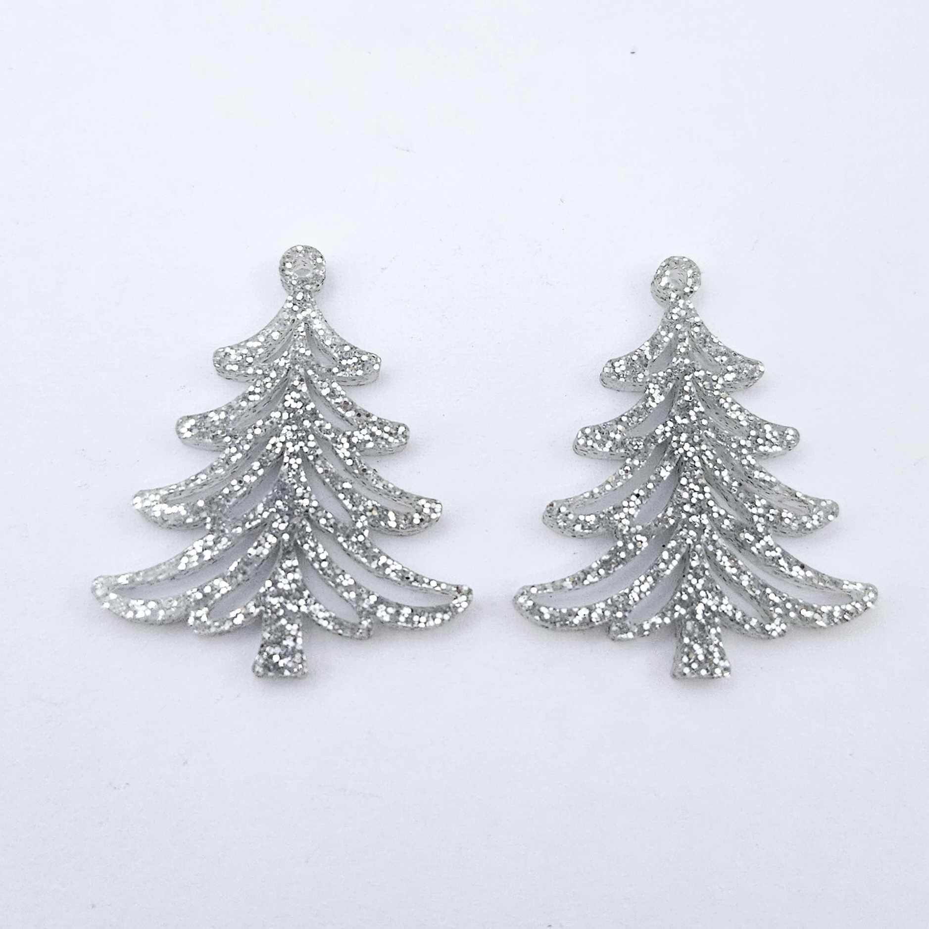 One pair of 35mm silver glitter acrylic Cascade Christmas Tree dangle earring blanks laying flat on a white background