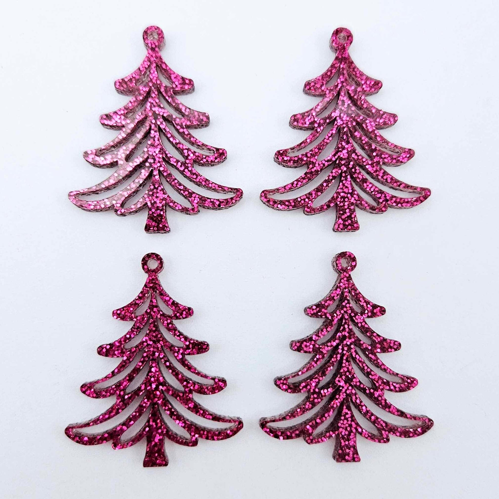 Two pairs of 35mm hot pink glitter Cascade Christmas Tree dangle earring blanks laying flat on a white background
