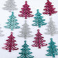 A mixture of hot pink glitter, teal glitter and silver glitter 35mm Cascade Christmas Tree dangle earring blanks laying flat on a white background