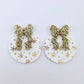 One pair of white Christmas Snowflake UV printed bauble dangle blanks with gold glitter bow connectors laying flat