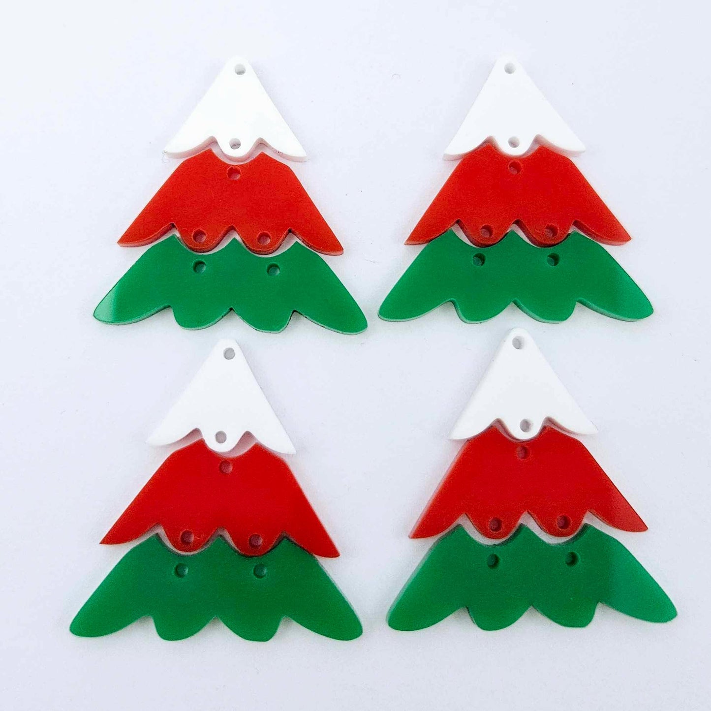 Two pairs of green, red and white 40mm three piece Christmas Tree dangle earring blanks laying flat
