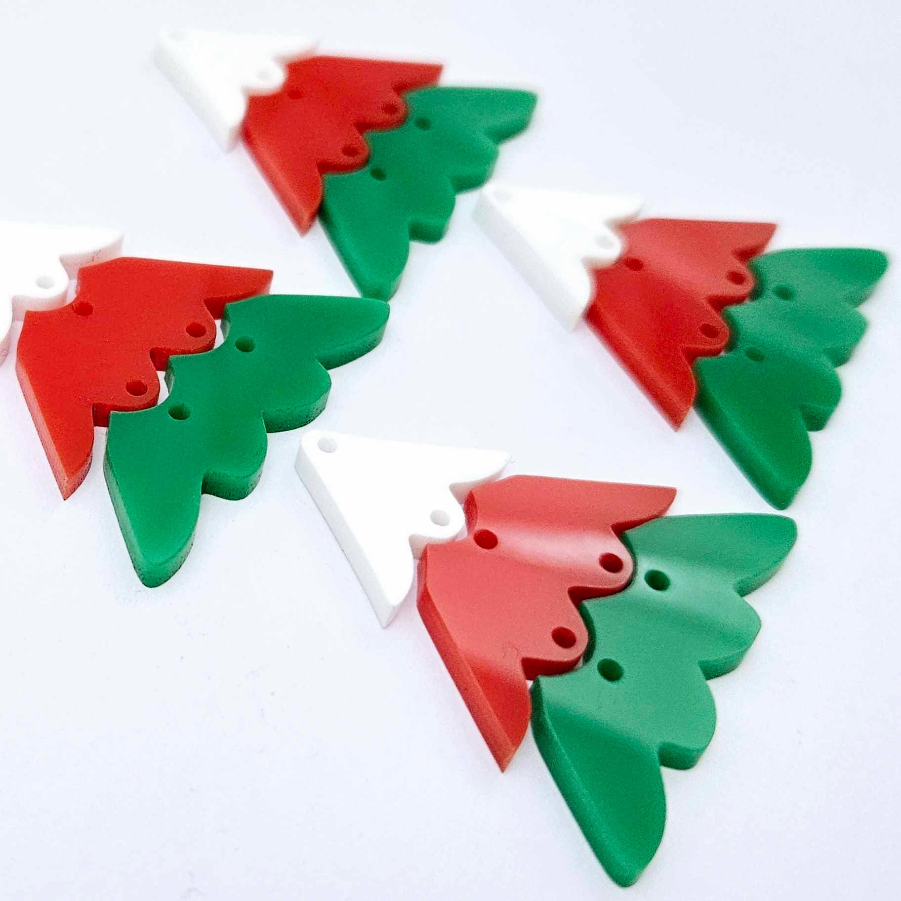 Two pairs of green, red and white 40mm three piece Christmas Tree dangle earring blanks laying flat