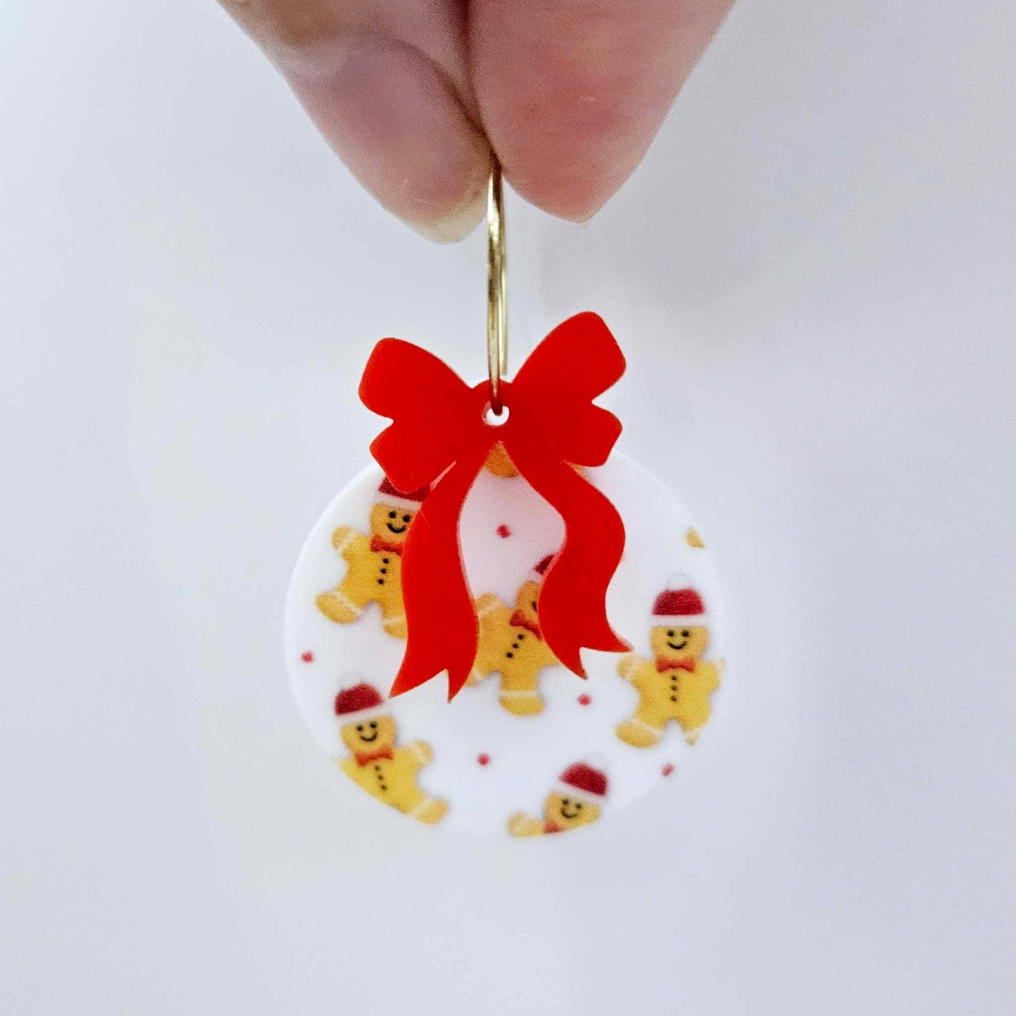 One Gingerbread Party UV printed bauble and included red bow assembled on a 20mm hoop