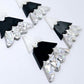 Two pairs of 40mm three piece Christmas Tree dangle earring blanks in holographic silver glitter, black and white marble acrylic laying flat on a white background