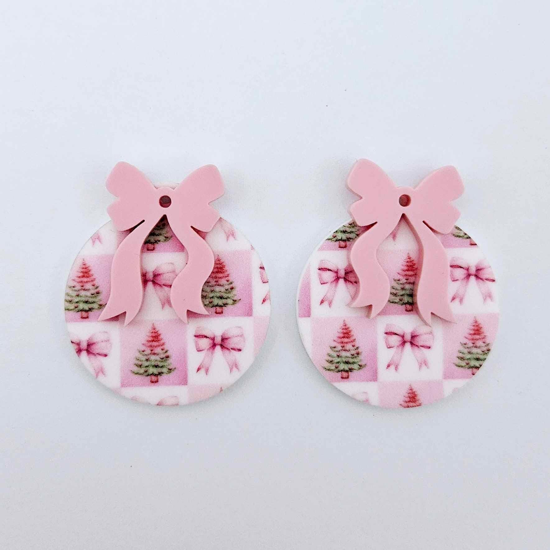One pair of Pink Patchwork UV printed bauble dangle blanks with included pastel pink bows laying flat