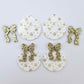 Two pairs of white Christmas Snowflake UV printed bauble dangle blanks with gold glitter bow connectors laying flat