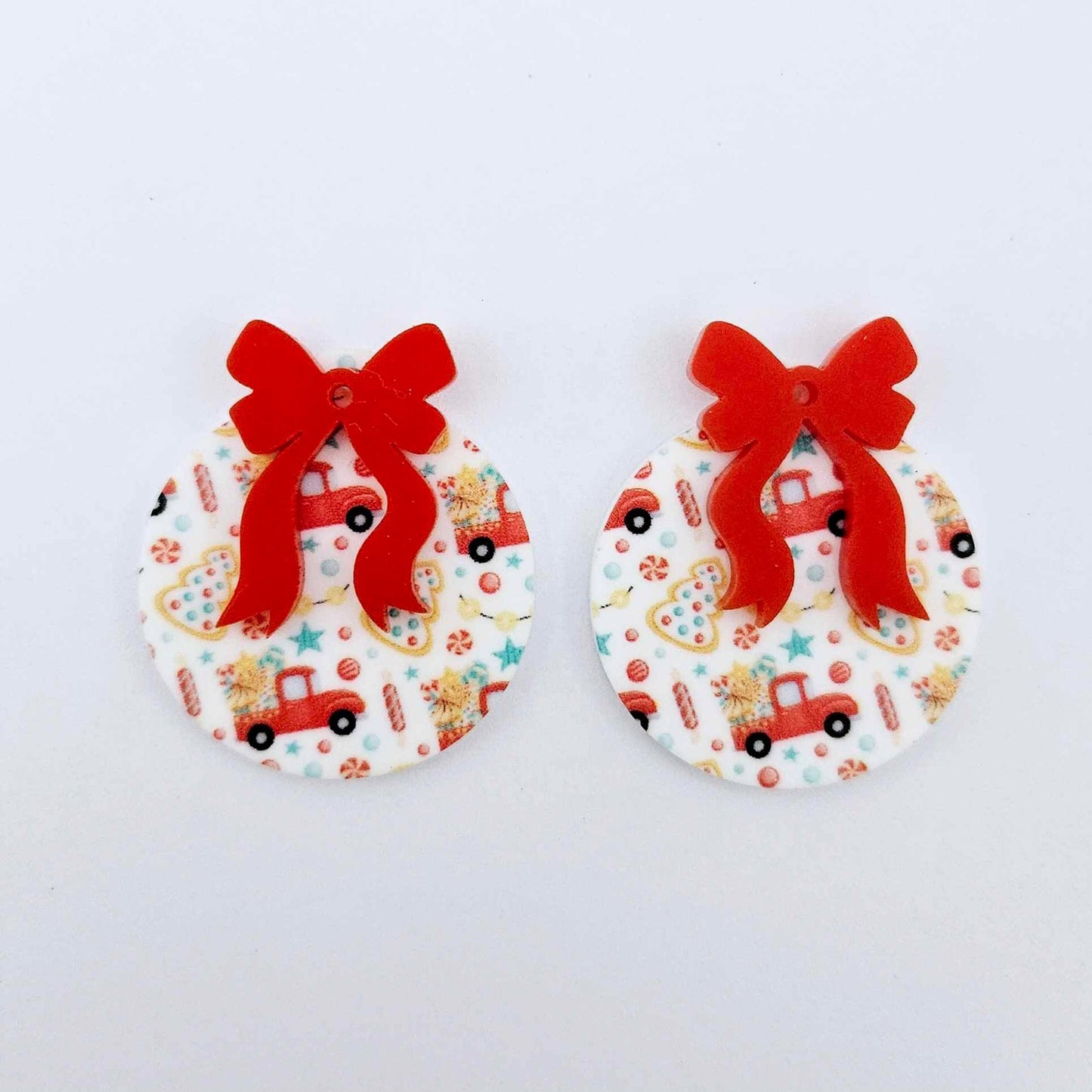 One pair of Vintage Truck UV printed bauble dangle blanks with included solid red bows laying flat