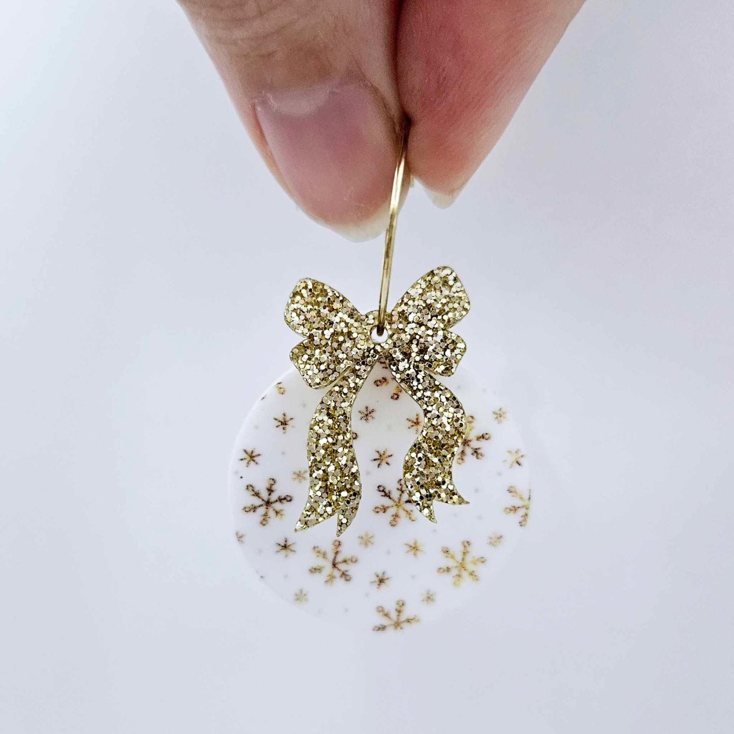 One Christmas Snowflake UV printed bauble dangle assembled on a 20mm hoop with a gold glitter bow 