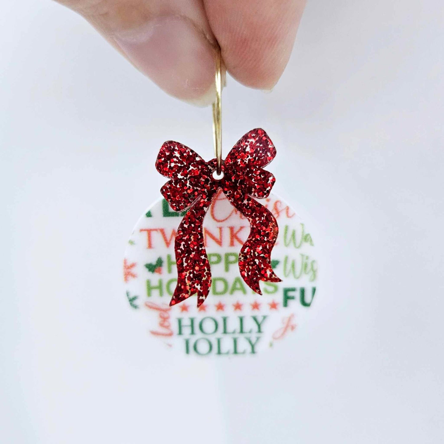 One Christmas Text UV printed bauble and included red glitter bow assembled on a 20mm hoop