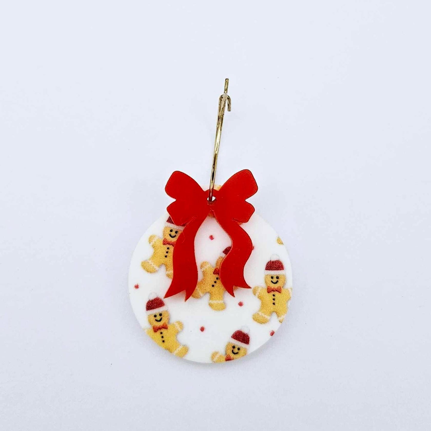 One Gingerbread Party UV printed bauble and included red bow assembled on a 20mm hoop